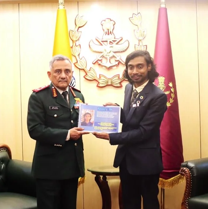 Apoorv Om and General Anil Chauhan holding the presented artwork at HQ IDS